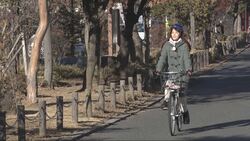 写真：自転車に乗るリポーター